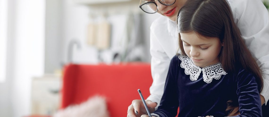 focused-young-woman-and-girl-drawing-together-at-home-4173332